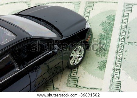 100 dollar bill background. stock photo : Black automobile over Hundred dollar bill background