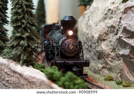Black model Locomotive on track layout with headlamp