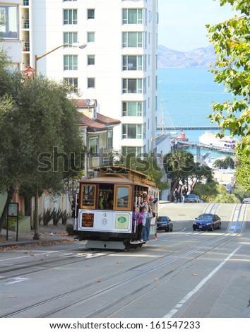 SAN FRANCISCO, USA - SEPTEMBER 14 : Passengers ride in cable car tram on September 14, 2012 in San Francisco, USA. Cable car ride is a very popular way to see the city