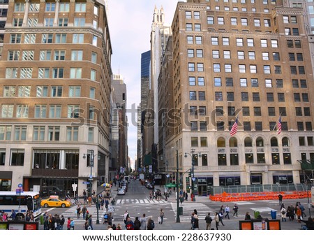 NEW YORK CITY, USA - OCTOBER 24, 2014: People and traffic on Fifth Avenue. Fifth Avenue is one of most expensive and popular shopping street in the world
