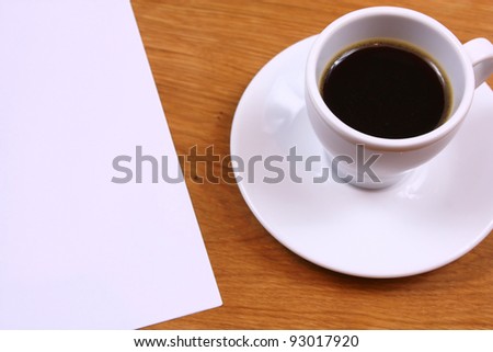 Black coffee and paper on desk