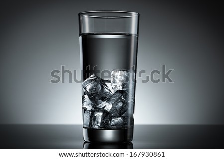 Drinking glass filled ice cube water top lighted