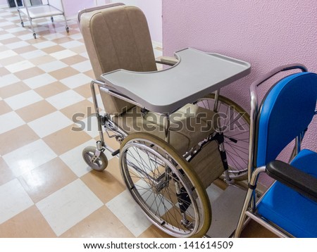 Empty wheelchair in a hospital corridor waiting for the the admission of an emergency or disabled patient requiring assistance for mobility