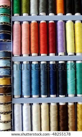 Sewing kit with colored spools of threads