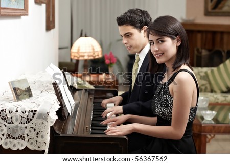 Young couple playing piano