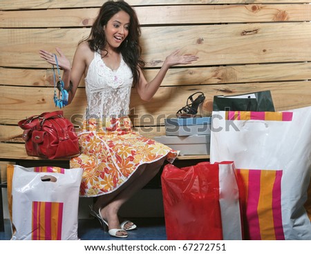 Young pretty woman excited with all the shopping she did