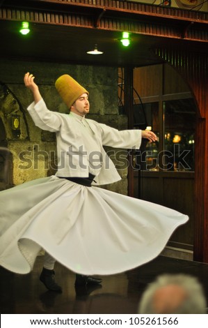 ISTANBUL, TURKEY - JUNE 03: Whirling dervish dancing in Cafe Mesale on June 03, 2012 in Istanbul, Turkey. Sufi whirling is a form of Sama or physically active meditation practiced by Sufi Dervishes.