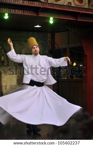 ISTANBUL, TURKEY - JUNE 03: Whirling dervish dancing in Cafe Mesale on June 03, 2012 in Istanbul, Turkey. Sufi whirling is a form of Sama or physically active meditation practiced by Sufi Dervishes.