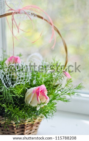 Beautiful bouquet of white and pink roses in a basket