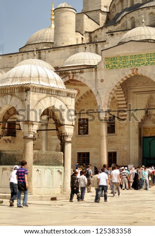 ISTANBUL, TURKEY - JUNE 03: Tourists in the courtyard of Sultanahmet Mosque on June 03, 2012 in Istanbul, Turkey. This is the biggest mosque in Istanbul of Sultan Ahmed is a great tourist attraction.