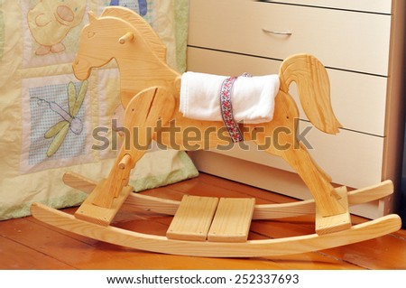 A beautiful handmade wooden horse in a kids\' bedroom
