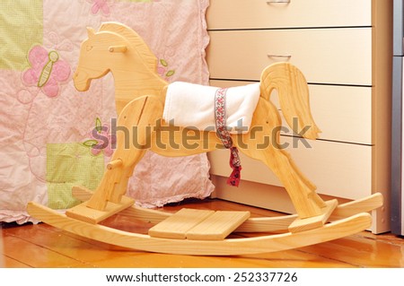 A beautiful handmade wooden horse in a kids\' bedroom