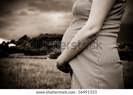 Mother-to-be holding her child inside her