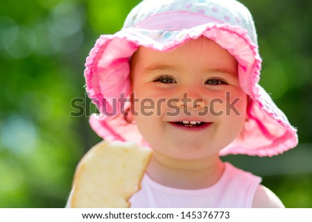 Smiling little girl feeding birds