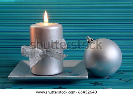 Christmas candle and silver ball on beautiful blue background