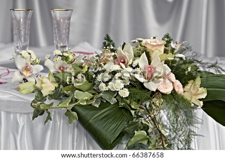 stock photo Two decorative wedding glasses with a bouquet of white orchids