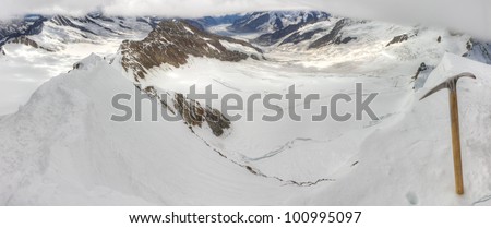 Aerial view of alpine mountain panorama over Aletsch glacier and surrounding mountain range with ice pick seen from top of 4,099 m high mount Moench