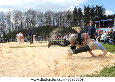 BONSTETTEN - APRIL 11: Swiss wrestling athletes fight for victory by throwing their opponent on his back April 11, 2010 in Bonstetten, Switzerland.  Overall victory was claimed by Jodok Huber.