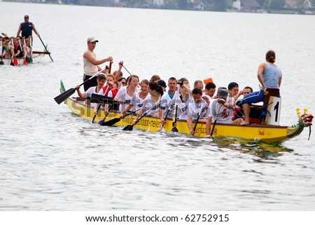 MEILEN - JUNE 12: Athletes fought hard for victory and had fun at the dragon boat racing festival June 12, 2010 in Meilen, Switzerland. Participants were also staff from institutes of EMPA and ETH