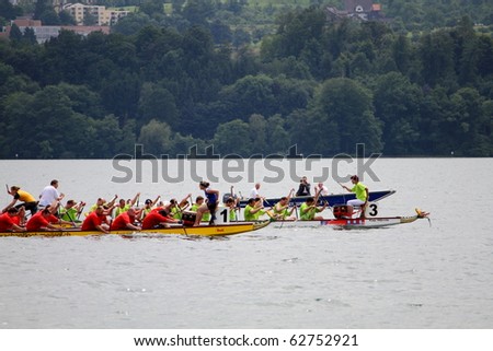 MEILEN - JUNE 12: Athletes fought hard for victory and had fun at the dragon boat racing festival June 12, 2010 in Meilen, Switzerland. Participants were also staff from institutes of EMPA and ETH