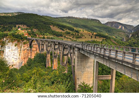 Durdevica arched Tara Bridge over green Tara Canyon. One of the world deepest Canyons and UNESCO World Heritage, Montenegro.