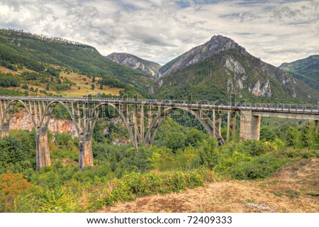 Durdevica arched Tara Bridge over green Tara Canyon. One of the world deepest Canyons and UNESCO World Heritage, Montenegro.