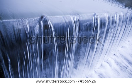 water cascade streaming down a lasher, cool white balance, concept for water saving, conservation, keeping water clean