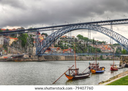 Old town Oporto at river Duoro, vintage port transporting boats an  famous bridge Ponte dom Luis, Portugal