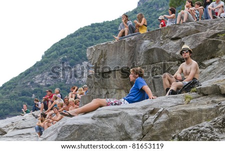 LOCARNO - JULY 23: Spectators enjoy the  WHDF European Cliff diving Championship 2011 with dives from up to 20m high at Ponte Brolla July 23, 2011 in Locarno, Switzerland.