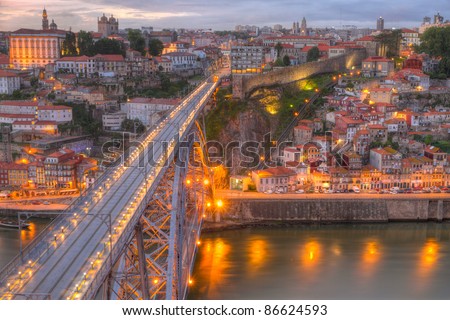 Lighted famous bridge Ponte dom Luis above Old town Porto at river Duoro at night, Portugal