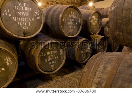 wooden barrels hold Port fortified wine to mature in wine cellars in Villa Nova de Gaia, Portugal