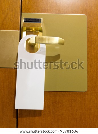 classic do not disturb sign on brass and wood hotel room door cleaned with copyspace for your text
