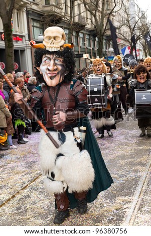 ZURICH - FEBRUARY 26: Participants in costumes perform a street procession of ZueriCarneval Fasnacht February 26, 2012 in Zurich, Switzerland. They perform Gugge Music and dress up as witches.