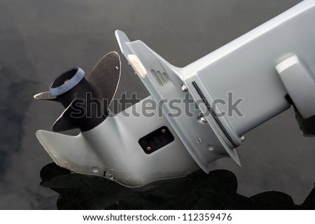 Fishing boat with a large propeller on land at a marine harbor in