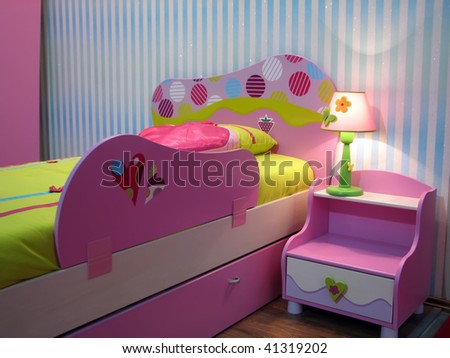 kids room with baby bed. pink baby bed and night locker.\
\
Pink bedside table.