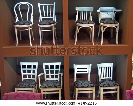 white wooden chairs exhibited. white wooden chairs.