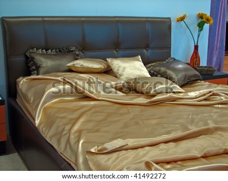 night bed with a golden sheets. king size bed.