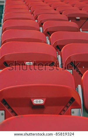 Red plastic stadium seats. Red stadium chairs.\
\
Giuseppe Meazza a San Siro stadium.