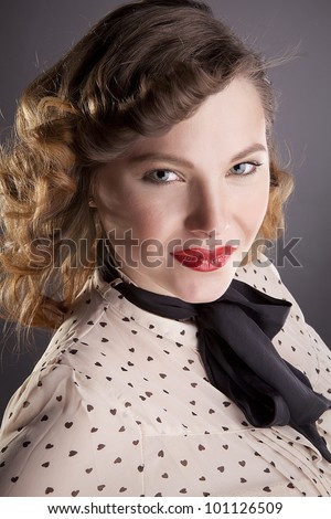 The girl the brown-haired woman with a black bow-tie poses in studio
