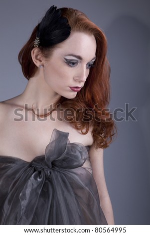 Beautiful red-haired girl with her hair in a light cloak over his naked body
