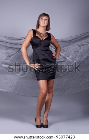 portrait of brunette girl in a black satin dress