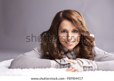 oung woman in a sweater and gloves