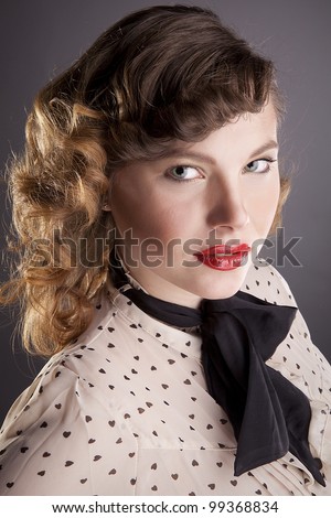 The girl the brown-haired woman with a black bow-tie poses in studio