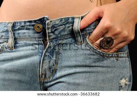 Woman\'s hand in the side pocket of jeans