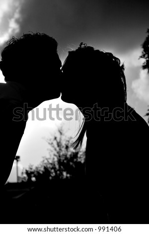 Silhouette of loving couple kissing