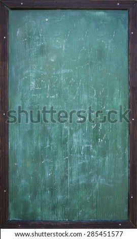 Green blank chalkboard with wooden frame and traces of chalk writing