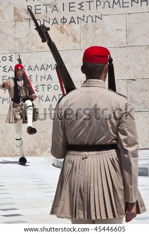 ATHENS - JULY 24: Ev zone guards dressed in traditional Greek uniform changing the guard at the Greek Parliament Building in front of Syntagma Square on July 24, 2009 in Athens, Greece.