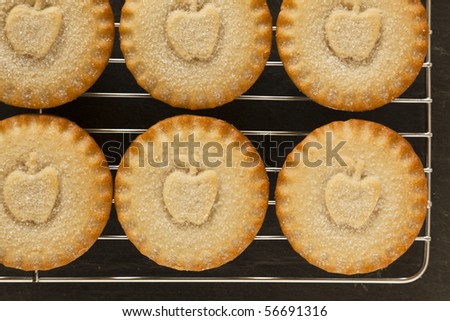 Apple Pies on a cooling tray with a slate background
