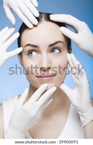 many rubber gloves touching the face of a woman