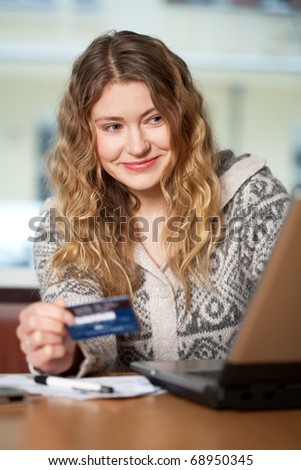 Young woman buys on the web